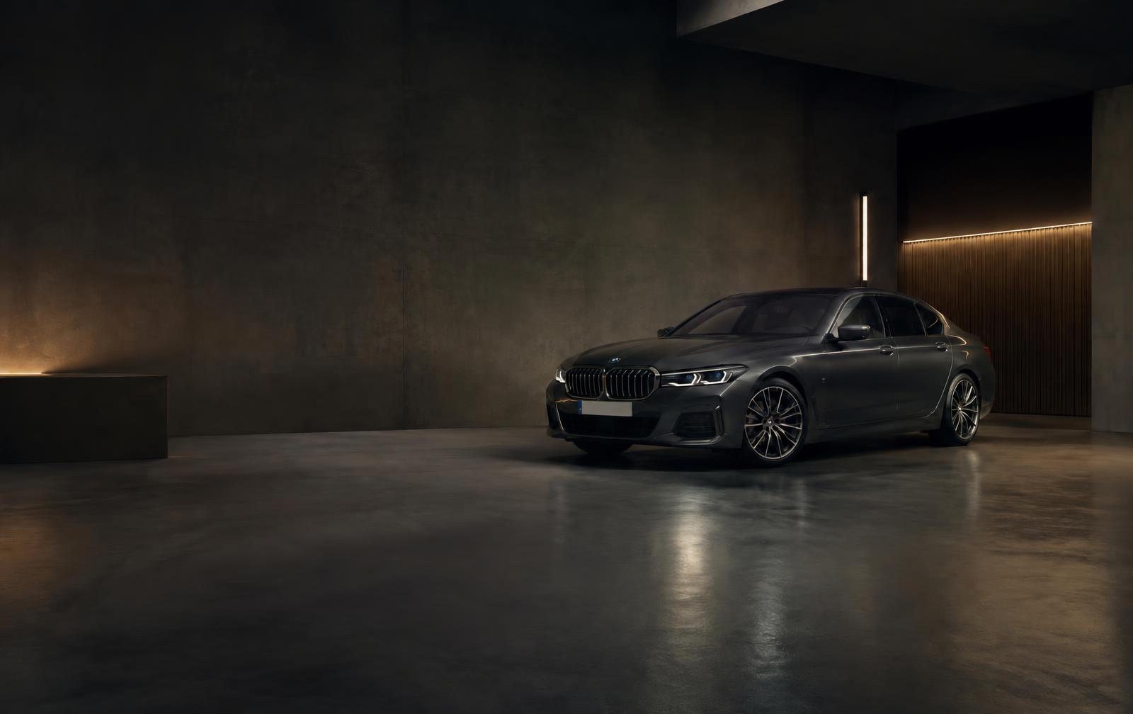 Dark grey saloon car in a softly lit showroom
